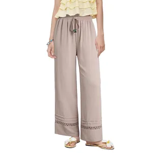 Casual high-waisted wide-leg trousers featuring drawstring waist and hollow lace hem detail