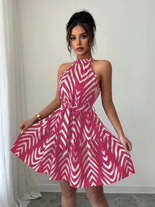 Detailed view of pink and white wave print halter neck mini dress with waist tie
