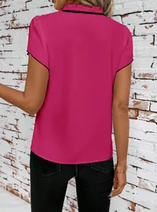 Back view of magenta short sleeve blouse with ruffled collar and black trim detail