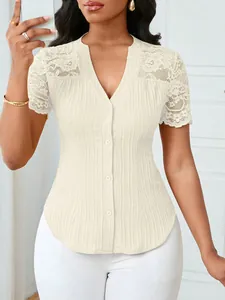 Detail showing elegant lace shoulder and button-down front of a slim-fit beige blouse.
