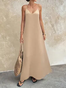 Elegant beige maxi camisole dress with a deep V-neck and crinkled textured fabric