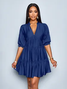 Elegant dark blue mini dress featuring deep V-neck, bubble sleeves, and tiered pleats