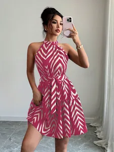Detail view of halter neck mini dress with vibrant pink and white zigzag pattern print.
