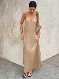 Detail of the textured fabric on this beige V-neck backless sleeveless slip maxi dress