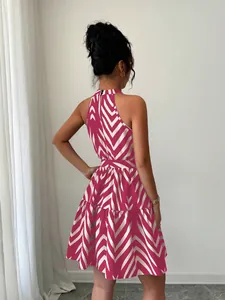 Back view of a pink and white wavy stripe halter sleeveless short dress for women