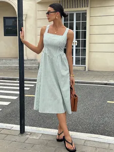 Full body view of a French style green striped sleeveless midi dress on a model