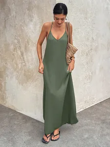 Full-length view of olive green V-neck backless cami maxi dress with texture on asian model.