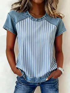 Close-up of casual short sleeve top featuring blue denim patchwork and vertical stripes