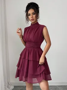 Elegante abito corto bordeaux senza maniche con collo alto e gonna a balze fluide.