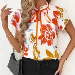 Elegant white floral print top with ruffled collar and orange bow tie short sleeve blouse