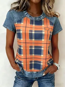 Close-up of casual women's top featuring patchwork denim and orange plaid pattern