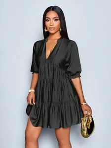 Model wearing elegant black deep V-neck mini dress with puff sleeves and ruffled tiers