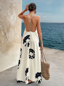 Detail view of a white and black tie-dye backless maxi dress featuring beaded strap accents