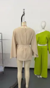 Detailed back view of a beige French vintage top featuring bell sleeves and waist tie