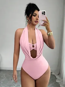 Close-up detail of pink halter neck bodysuit featuring deep V cutout and stylish ring accent