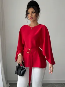 Elegant red French vintage blouse featuring bell sleeves and a matching waist belt detail.