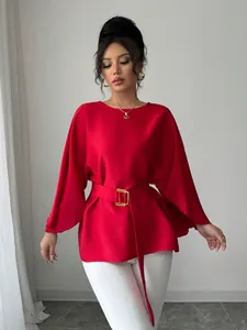 Close-up detail of a French retro red top featuring elegant bell sleeves and a belted waist