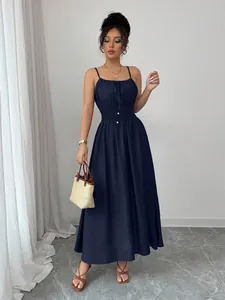 Full-body view of elegant navy blue smocked waist spaghetti strap maxi dress