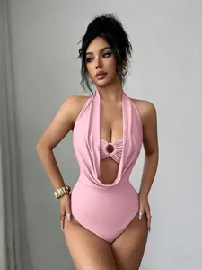Macro detail of the elegant pink halter neck bodysuit featuring a stylish ring cutout design