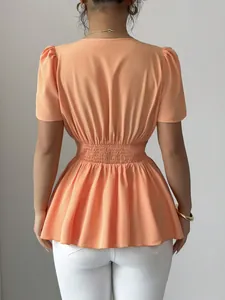 Vista posteriore dettagliata di camicetta arancione con scollo a V e vita elasticizzata