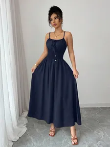 Full-length view of navy blue camisole maxi dress with smocked waist and spaghetti straps
