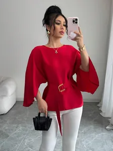Elegant red blouse with vintage bell sleeves and a stylish gold buckle belt detail.