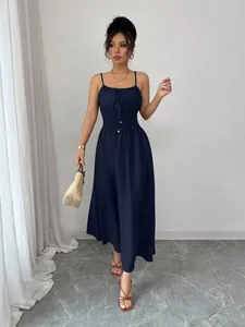 Detailed view of navy blue strap dress with smocked waist and gathered bust detail.
