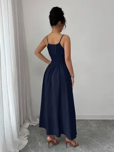 Back view of a dark navy blue maxi dress featuring a smocked waist and thin straps.