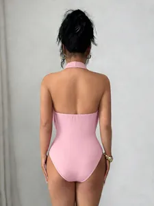 Back view of a sleek pink halter neck bodysuit designed for a slim fit and elegant look.