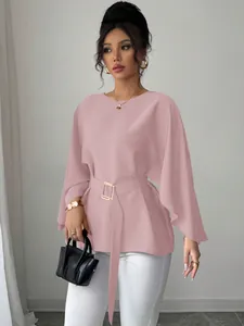 Detailed macro view of a pink French retro flare sleeve blouse with a matching waist belt.
