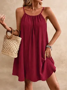 Elegant detail of a maroon sleeveless mini dress with breathable textured fabric