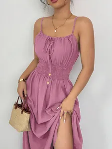 Detailed view of a mauve smocked waist spaghetti strap dress with side slit