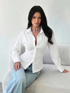 Detailed shot of a slim-fit white long-sleeved shirt with elegant V-neckline on a model