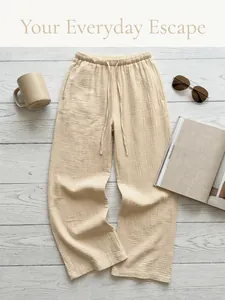 High-quality detail shot of beige cotton wide leg lounge pants with drawstring waist