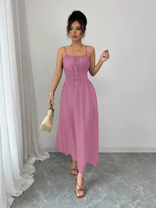 Full length view of a mauve spaghetti strap dress with smocked waist and tie front detail