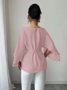 Detailed back view of a pink French vintage blouse featuring elegant bell sleeves and belted waist.