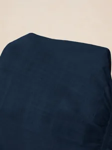 Close-up of the dark navy blue woven fabric texture for a stylish women's V-neck blouse