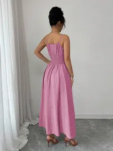 Detailed back view of a pink midi dress featuring an elastic smocked waist design