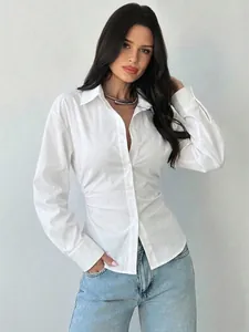 Detailed view of women's white slim fit waist-cinched long sleeve button-up shirt
