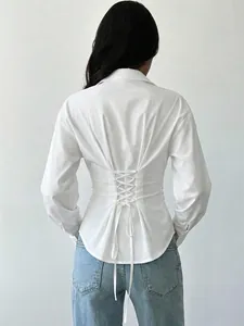 Detailed macro view of white slim-fit women's shirt with corset lace-up back design