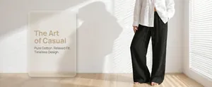 Detail of black pure cotton wide-leg trousers showing textured fabric and relaxed fit