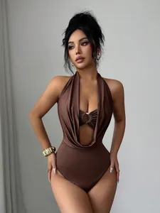 Detail of brown deep V-neck halter bodysuit featuring a metallic ring and slim cut-out.