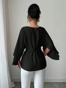 Back view of elegant black French vintage blouse with flared sleeves and waist belt