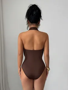 Detailed back view of a slim-fitting brown halter neck bodysuit for a sleek silhouette