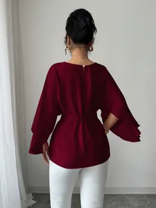 Back view of a French retro burgundy blouse with layered bell sleeves