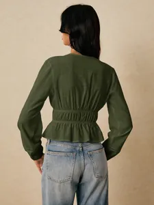 Back view of a dark green long-sleeved peplum blouse with elasticated waist details