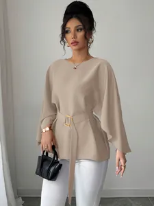 Detailed view of elegant French retro top with stylish flare sleeves and matching belt accessory
