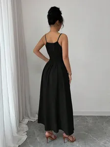 Back view of a black spaghetti strap dress with a shirred waist and midi length