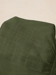 Close-up of dark green textured fabric showing fine linen-blend weave details