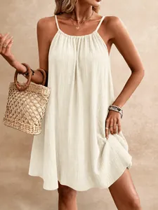 Detailed view showing the elegant cream halter mini dress with textured crinkle fabric